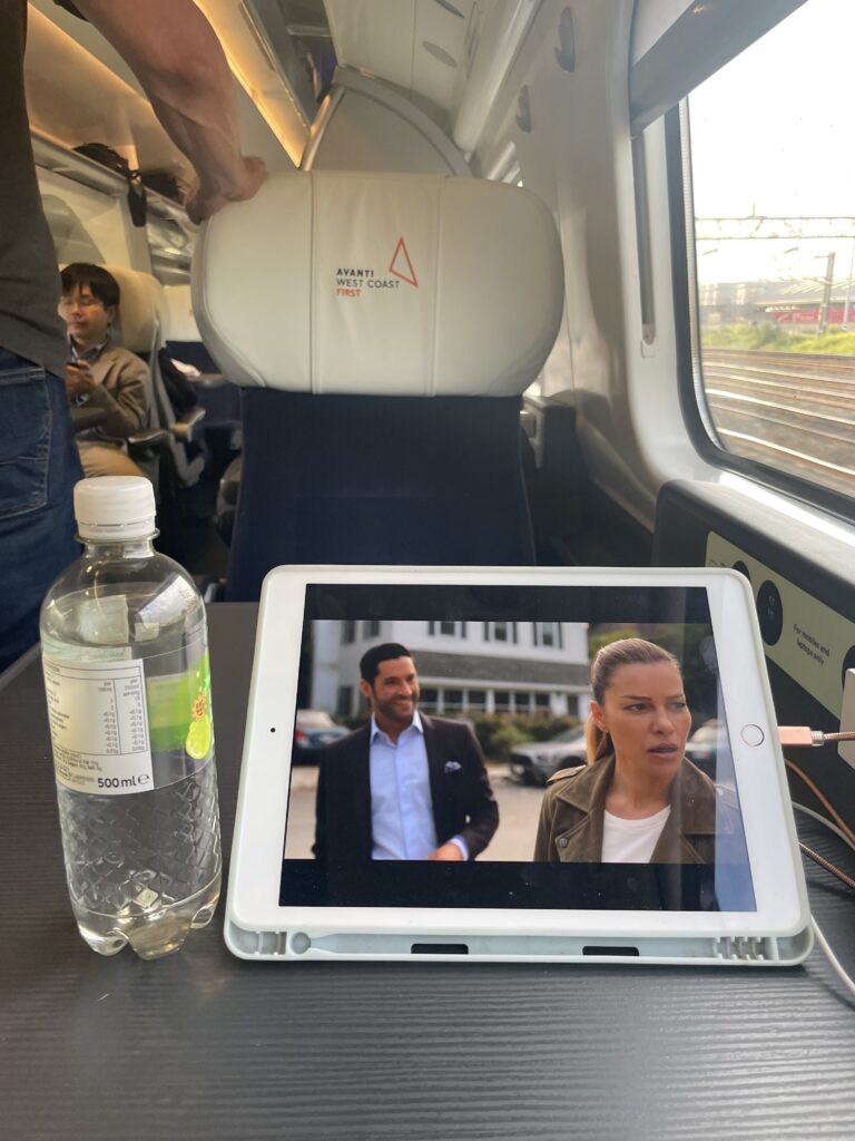 An iPad is playing the TV show "Lucifer" while on the train. 