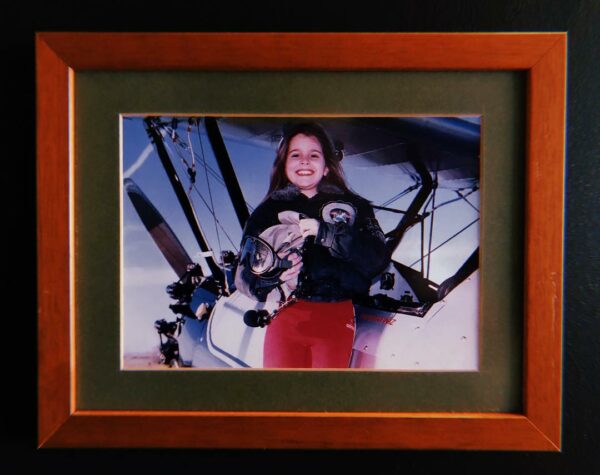 A photo SEMİN's as a child in front of a Boeing Stearman