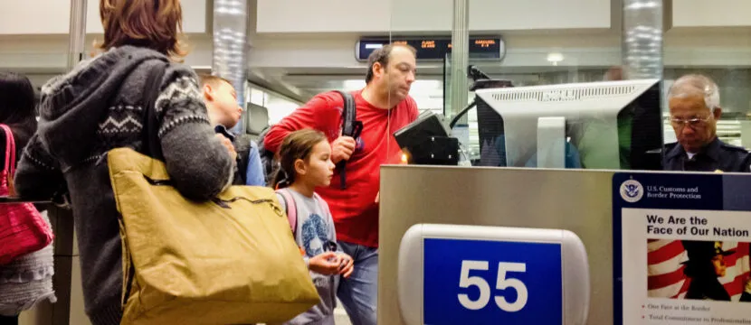 U.S. Immigration officer checking documents of tourists
