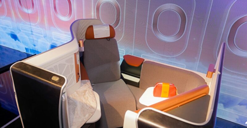 The SAUDIA new Business Class seat on the Airbus A321 XLR. The seat is grey with a burnt orange headrest.