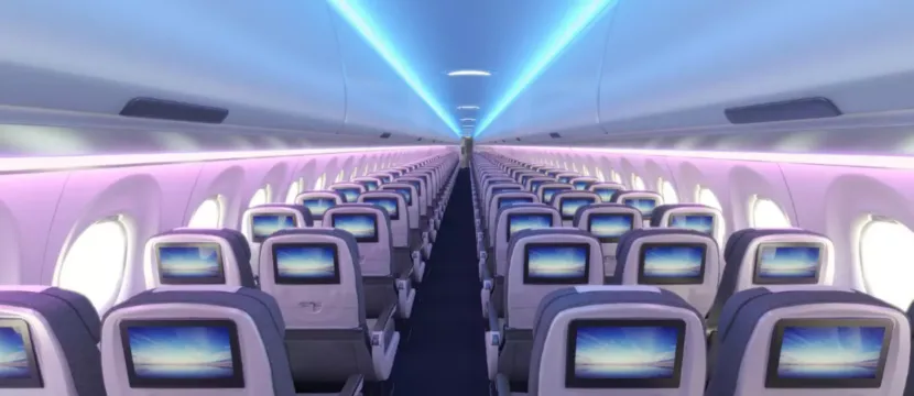 Airbus Airspace Cabin for the A220 is in a 2-3 layout and being lit by blue and purple LED lights.