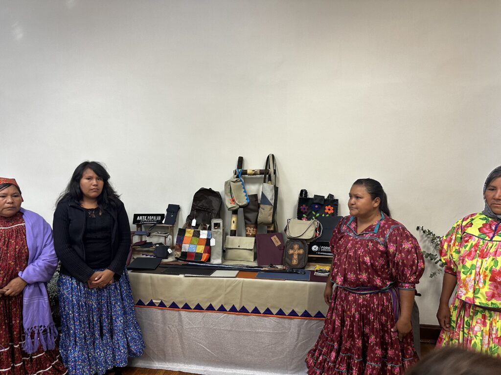 Two women are at a stand displaying the various products made by materials from Soisa