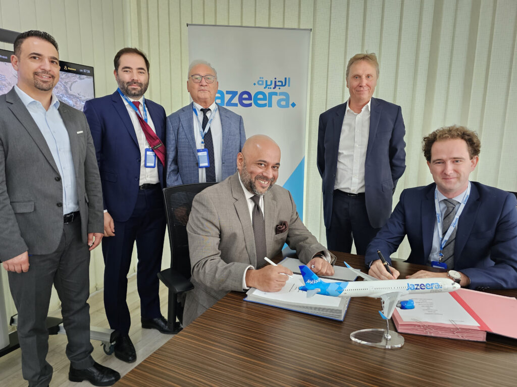 Executives of Jazeera Airways and Expliseat are posing for a photo while signing the agreement.