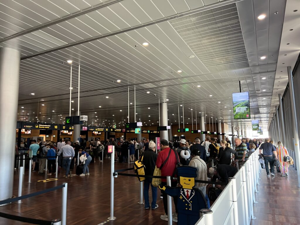 Copenhagen Airport security gate. A Lego-branded sign guides families to a special line of entry.