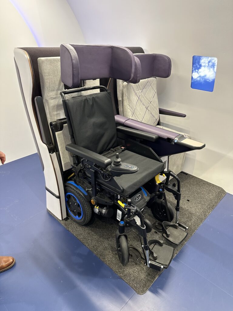 Air4All wheelchair seat prototype on display at AIX 2023 in Hamburg. This image shows a wheelchair slotted into the space created when the seat pan retracts.