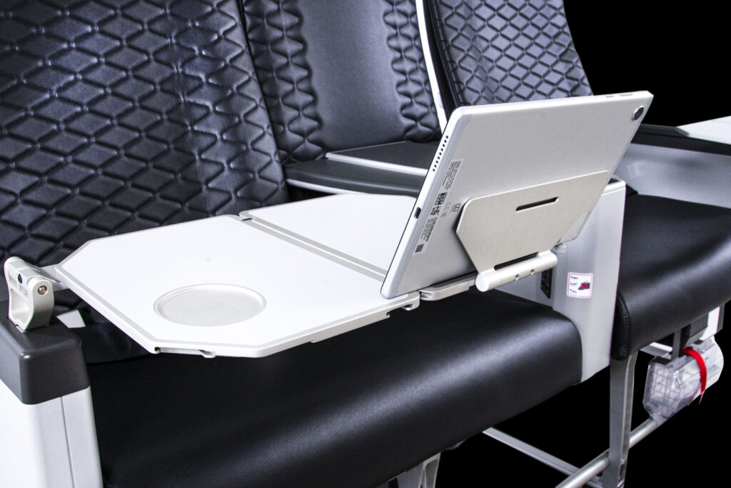 A tablet holder on a Premium seat's in-arm tray table.