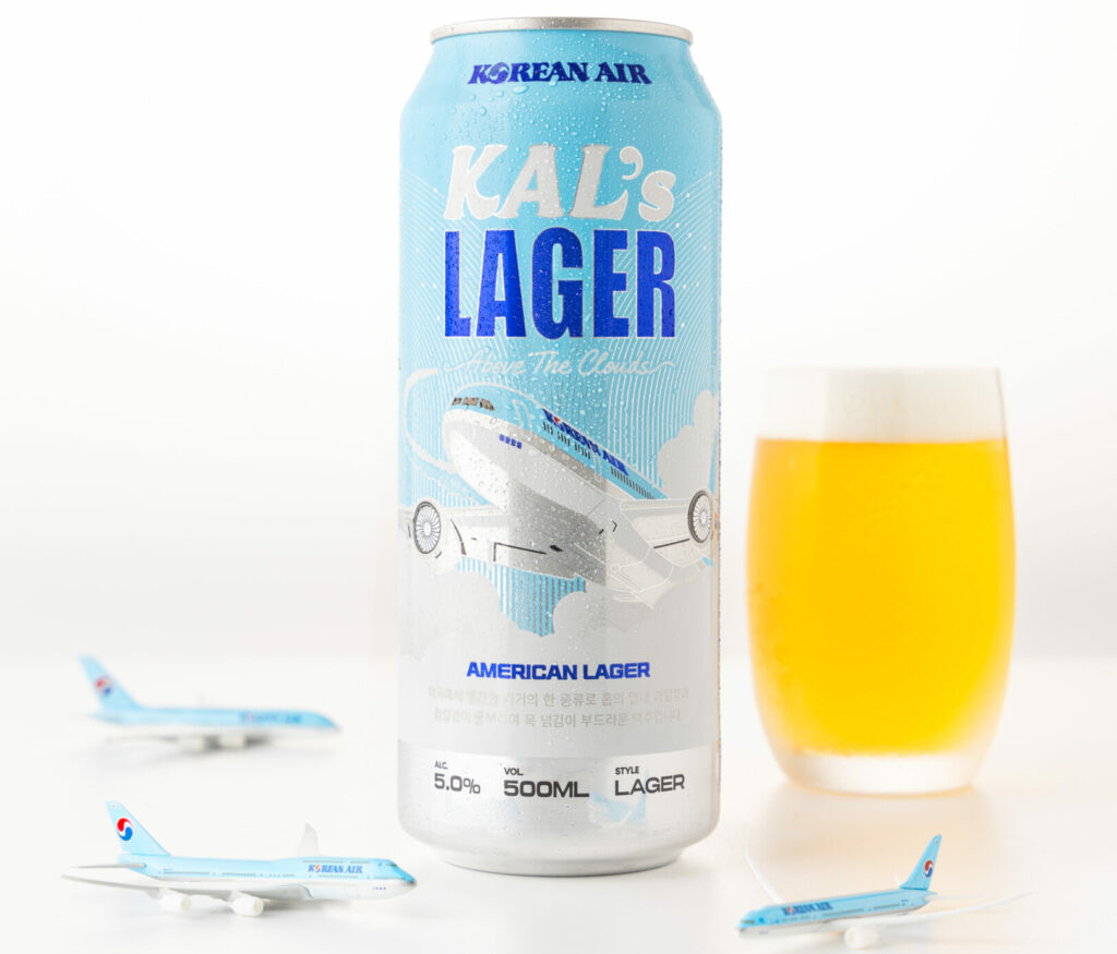 Little toy aircraft in Korean Air's livery sit around a can and glass of KAL's Lager