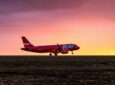 PLAY aircraft on the runway at sunset. Image PLAY