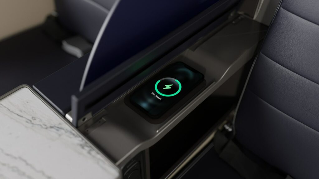 A close up of United First wireless charger in the armrest of the seat.