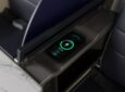 A close up of United First wireless charger in the armrest of the seat.