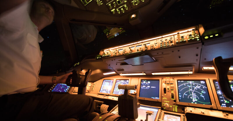 A 777 cockpit on a flight from Amsterdam. The ACARS system is clearly in view. LEO