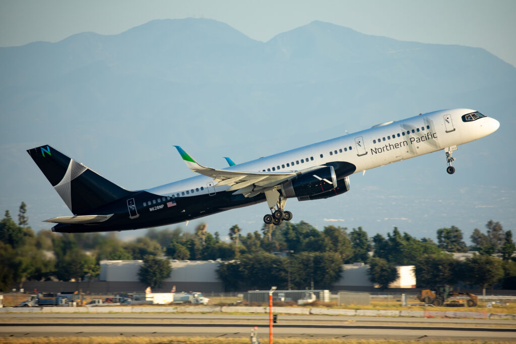 Northern Pacific 757 on takeoff with mountains in the background. 