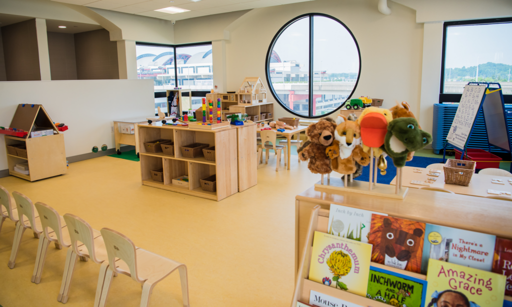 Pittsburgh International Airport childcare center is brightly lit by a large windows. Many toys fill the room.