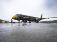 Embraer E195-E2 with black livery and a yellow nose that says 'Profit Hunter' is parked. caac