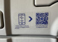 A QR code on the back of an aircraft seat linking to the Aegean Wi-Fi portal for the EAN connectivity