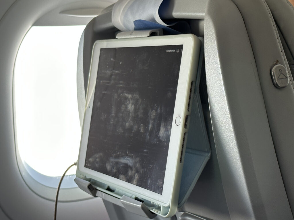 A tablet is secured to a seatback device holder.