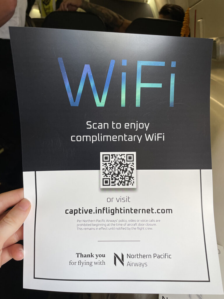 A pamphlet with a QR code that allows passengers to connect to the inflight wi-Fi.