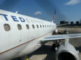 United Express E175 parked and ready to board on a sunny day.
