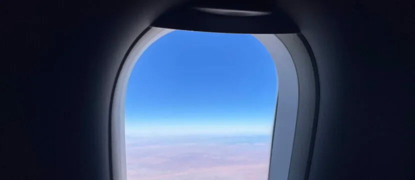 A photo from inside an Airbus A320 of the window and the landscape outside as the jet flies at 33K ft. Wireless IFE provider AirFi is now offering AirFi LEO with window-mounted antennas to transmit via Iridium Certus 100.