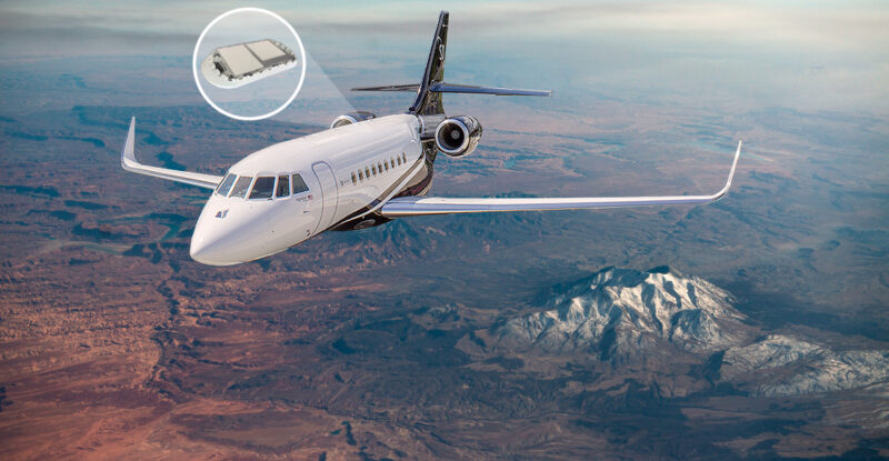 A aircraft is flying over mountains. A bubble is coming out of the aircraft to Illuminate that there is a gilat antenna on there.