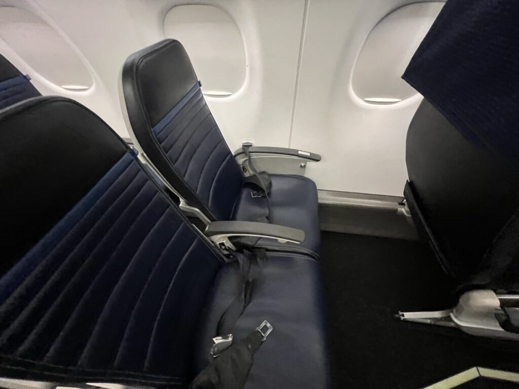 Economy Plus seats on the United Airlines E175. The seats are blue and black.