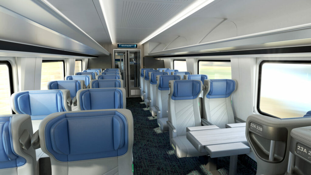 Amtrak Airo coach class seating is grey with blue adjustible headrests.