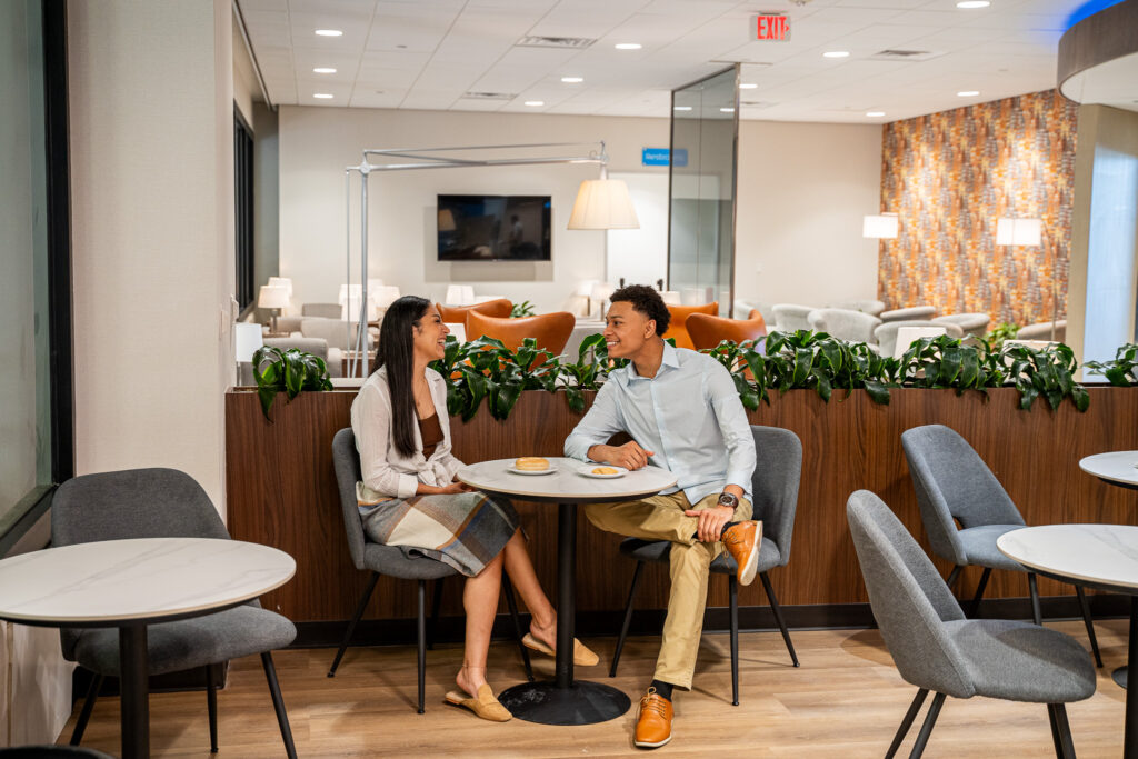 A seated couple enjoys the KLM Crown Lounge in Houston.