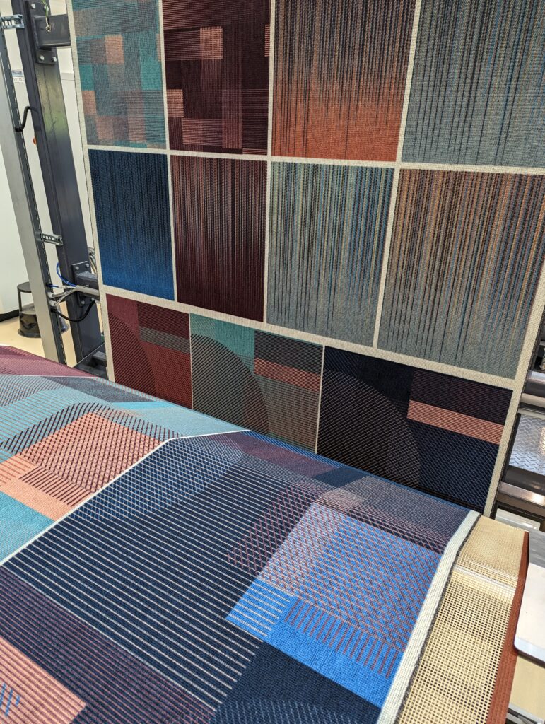 A varity of carpet color patterns are seen displayed on the wall at Lantal. 