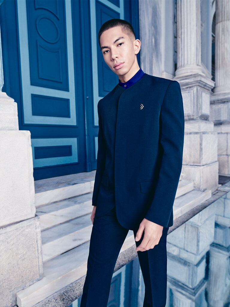 A man is modeling the sleek dark blue Aegean crew pant suit uniform by Zeus+Δione