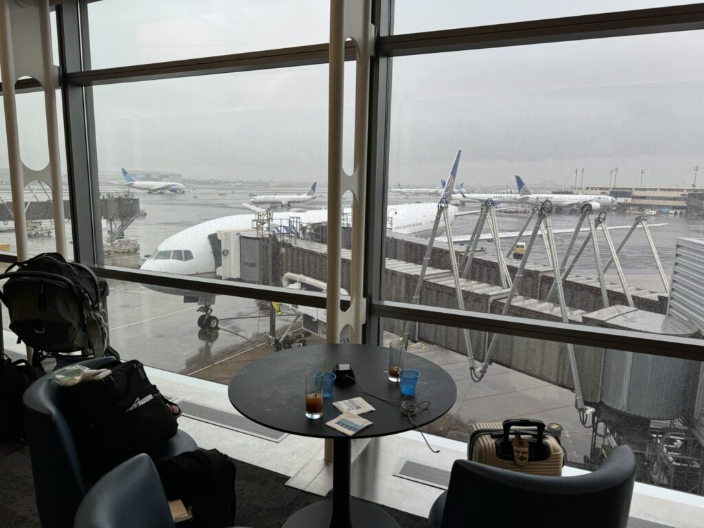 Window seats overlooking the airport gates in the United Club lounge in Newark Airport.