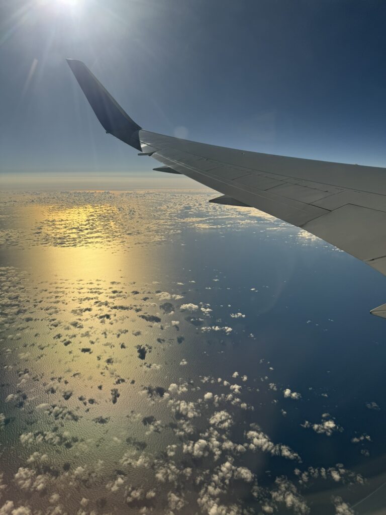 Photo of the 767 wingtip as the aircraft flies over water