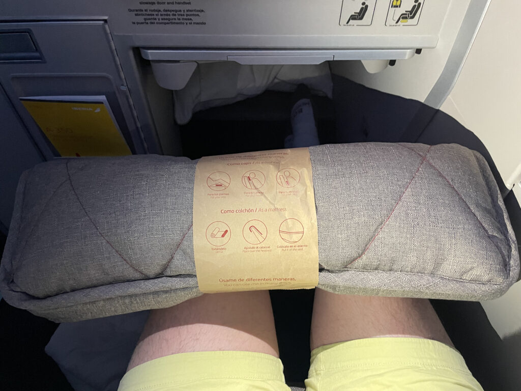 The Iberia mattress topper is sitting rolled up on a passenger's knees