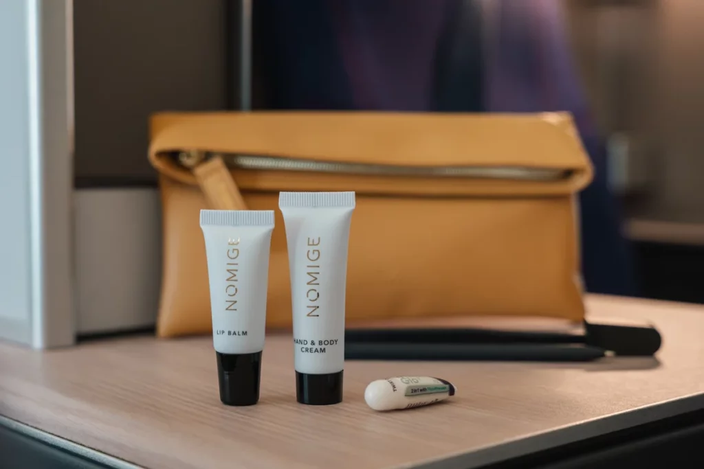 Skincare products are laid out in front of the Brussels Airlines amenity kity