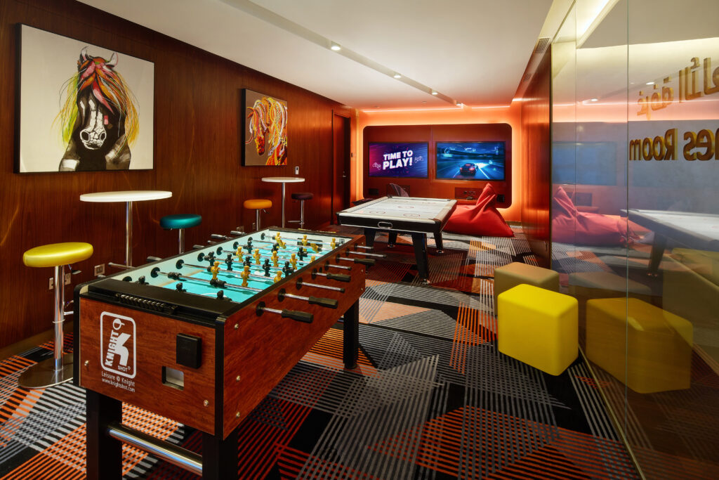 A games lounge shows a foosball table and various other forms of gaming entertainment.