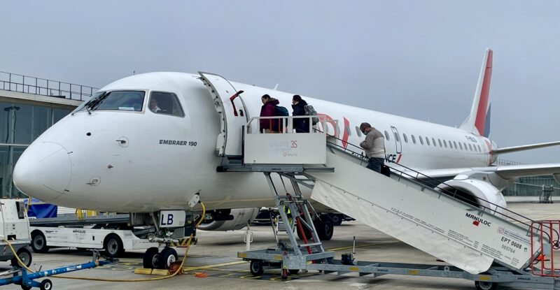 Passengers board an aircraft operated by Hop