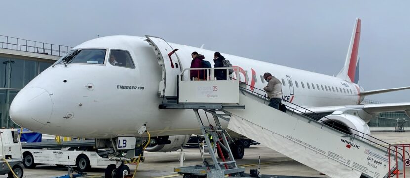 Passengers board aircraft operated by Hop