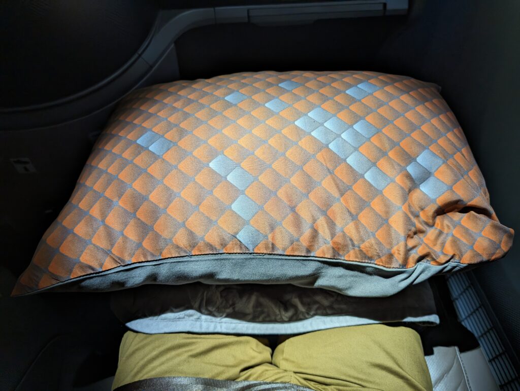 A diamond geometric patterned blue and orange pillow.