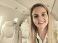 Nadia Coetzee of ExecuJet MRO Services Europe is smiling whilst seated in a business jet with an all-cream colored interior.