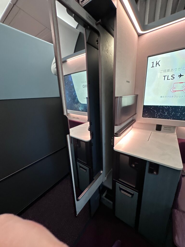 A large, slide-out mirror in the JAL first class suite.