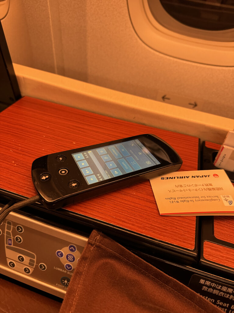 A mobile device and information card sit on the suite's side table.