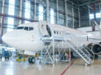 White passenger airplane in the hangar. Airliner under maintenance. Image to connote CarlisleIT