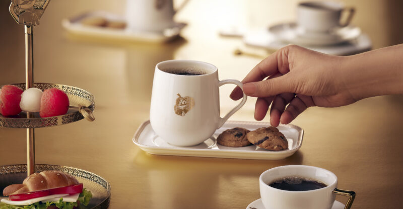 Maharaja is seen on the coffee mug as displayed with other various crockery items for Air India.