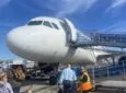 The nose of the Allegiant aircraft as it is being boarded via ramp