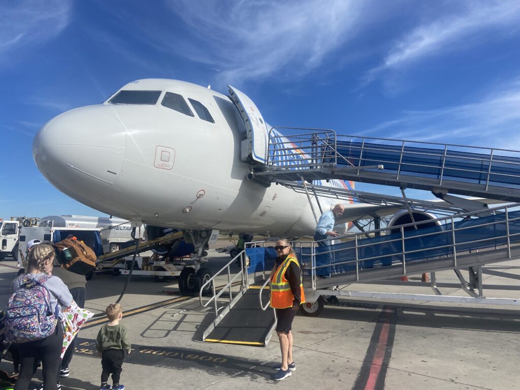 Close up of the nose of the Allegiant aircraft as the aircraft is being boarded via ramp