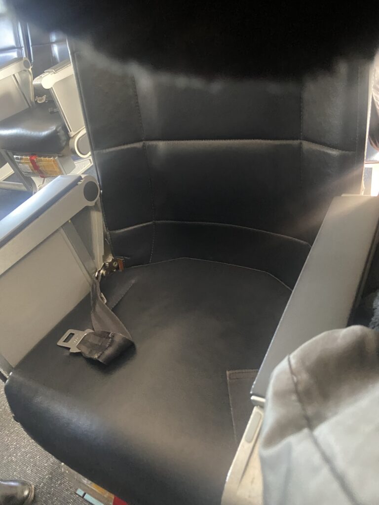 A close up of the dark grey Allegiant seat. 