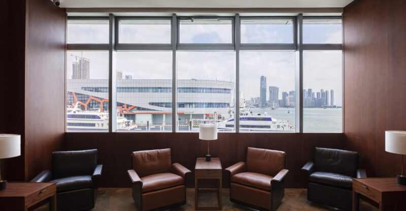 Comfortable chairs are positioned beside the large windows in the Cathay Pacific lounge at the Shekou Cruise Home Port.