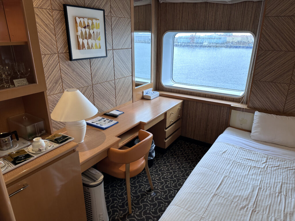 A desk and bed in the room onboard the Taiheiyo (Pacific) Ferry