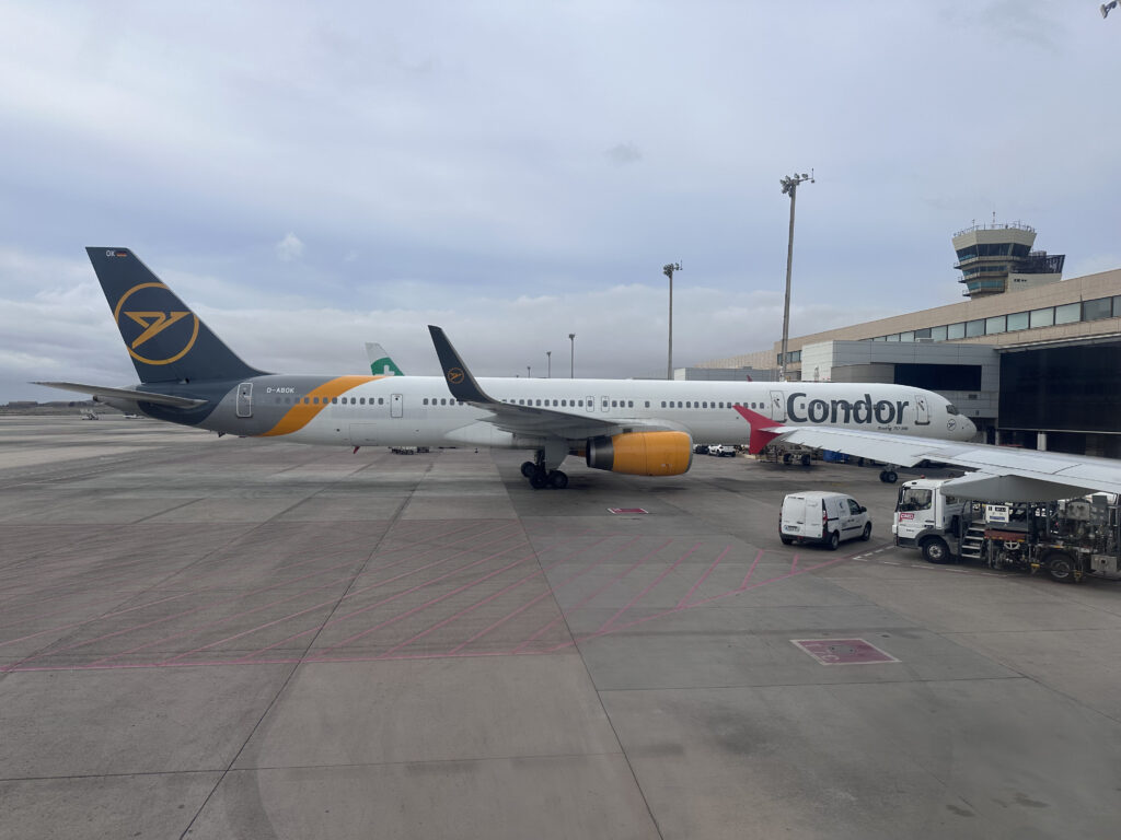 Leisure travel airline Condor's 757 is parked at the gate. 