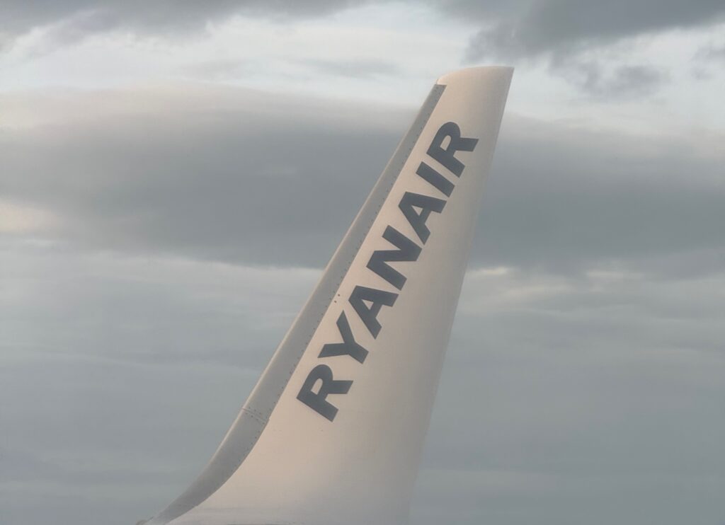 Wingtip of Ryanair 737 with the word Ryanair written in grey.