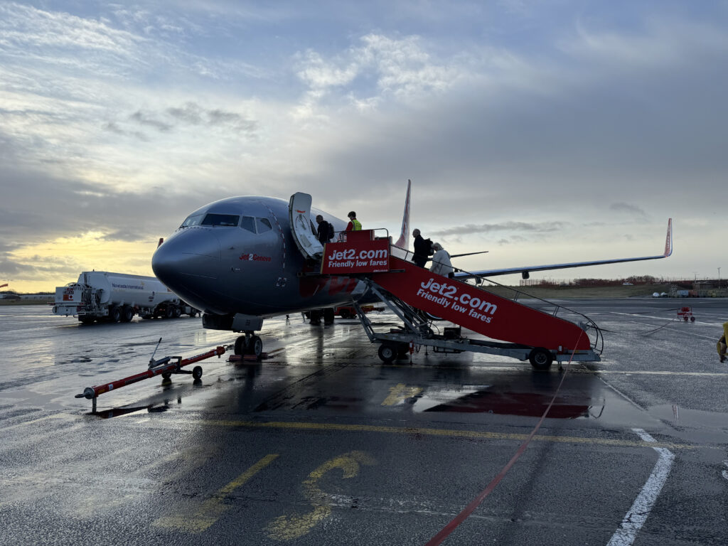 Passengers enter the aircraft via airstairs.